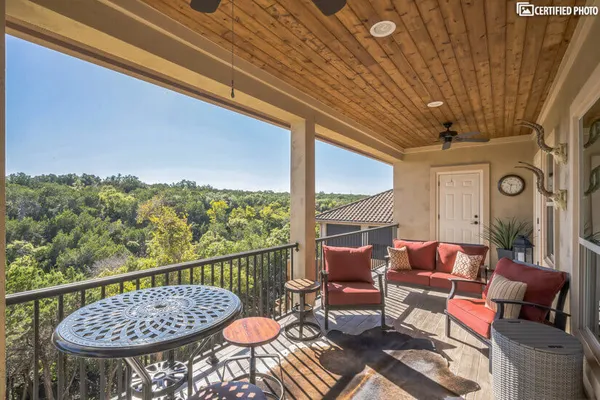 a view of a chairs and table in the balcony