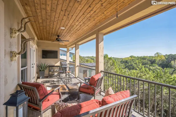 a balcony with wooden floor and outdoor seating