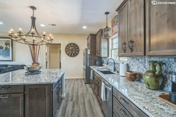 a kitchen with a sink a counter space cabinets and stainless steel appliances