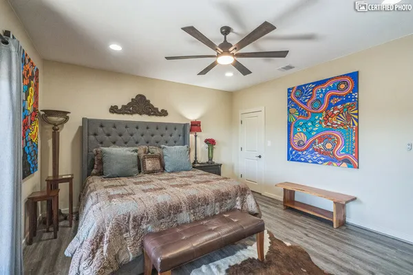 a bedroom with a bed and a chandelier