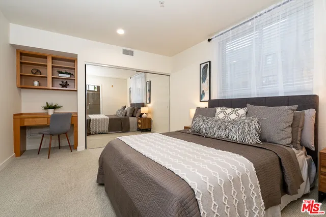 a bedroom with a bed and a table