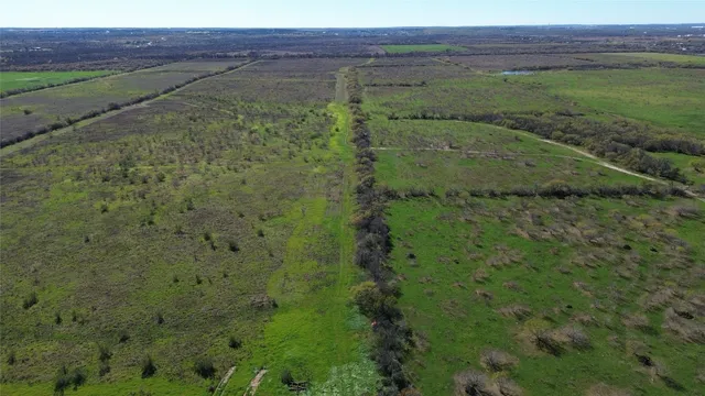 a view of a field with an ocean view