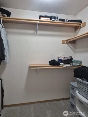 a bedroom with a bed and a mirror