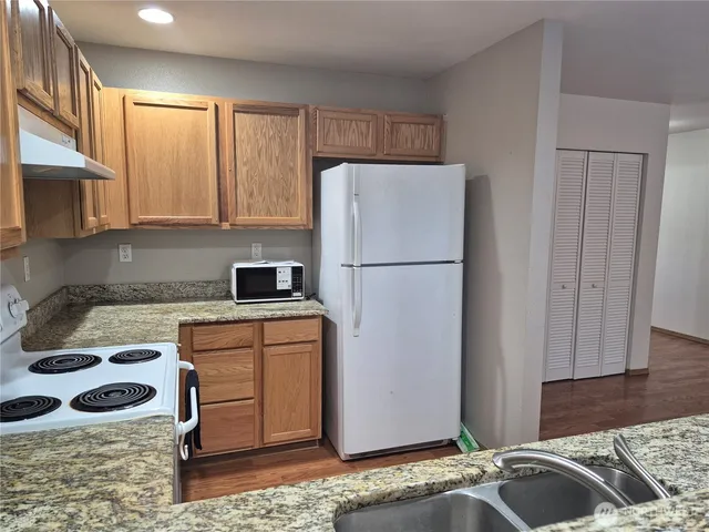 a kitchen with a refrigerator sink and stove