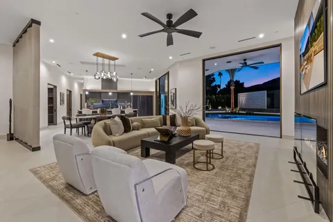 a living room with furniture and a floor to ceiling window