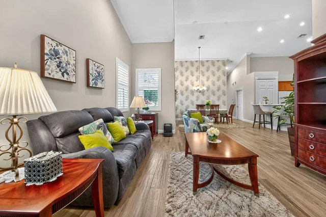 a living room with furniture and a chandelier