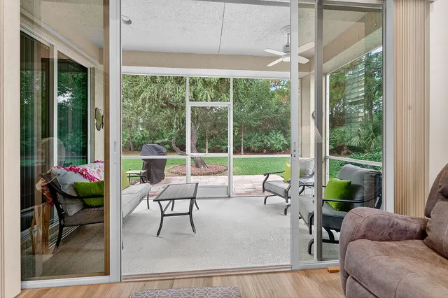 a living room filled with furniture and a large window