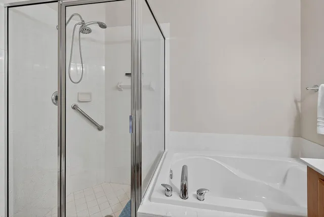 a bathroom with a tub and a shower