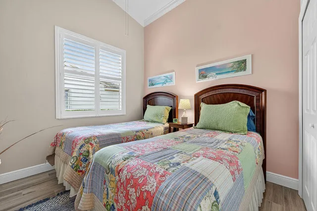 a bedroom with two beds and a window