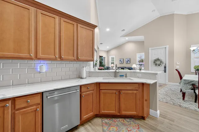 a kitchen with a sink cabinets and wooden floor