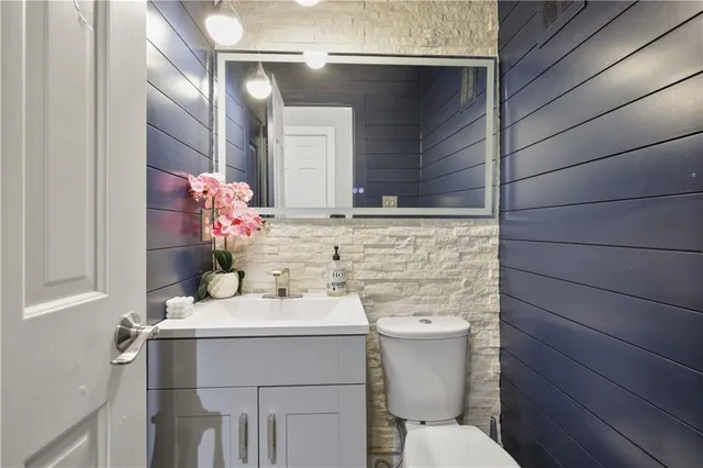 a bathroom with a sink toilet and mirror