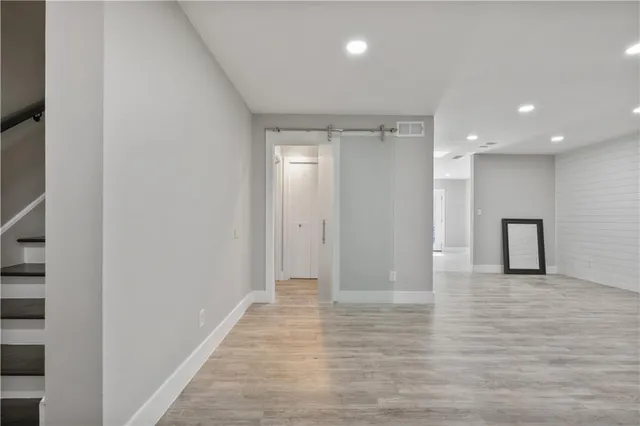 a view of an empty room with wooden floor