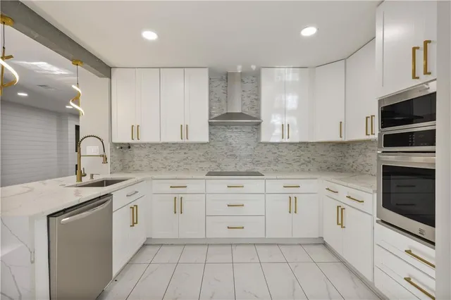 a kitchen with granite countertop white cabinets white stainless steel appliances with a sink and dishwasher