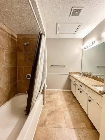 a bathroom with a granite countertop sink a toilet and shower