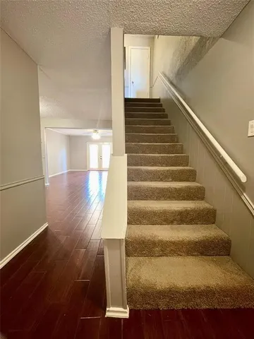 a view of entryway and hall with wooden floor