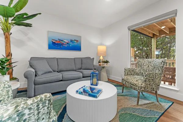 a living room with furniture and a potted plant
