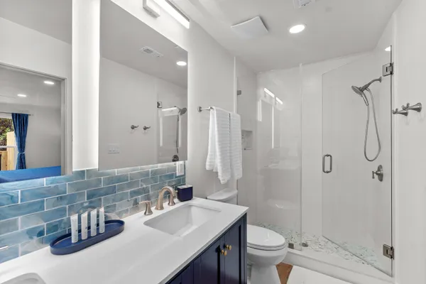 a bathroom with a toilet and a shower