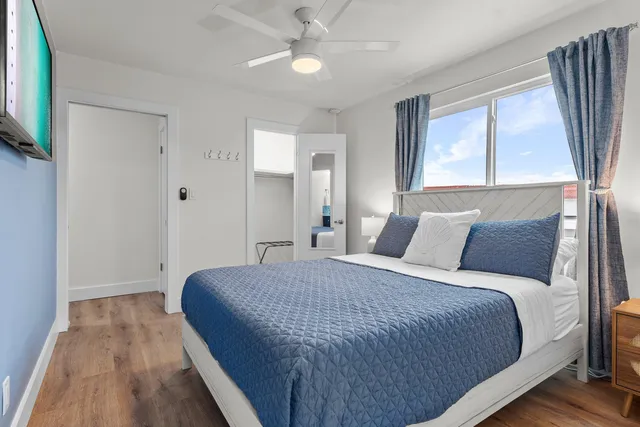 a patio with wooden floor a yard a table and chairs
