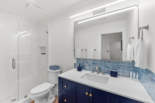 a view of a house with a small yard and wooden fence