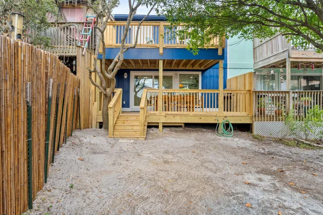a view of a kitchen with a fridge and wooden cabinets