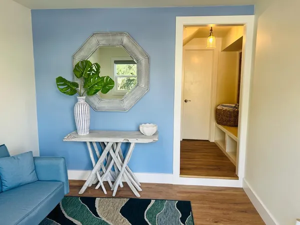 a living room with furniture and a potted plant