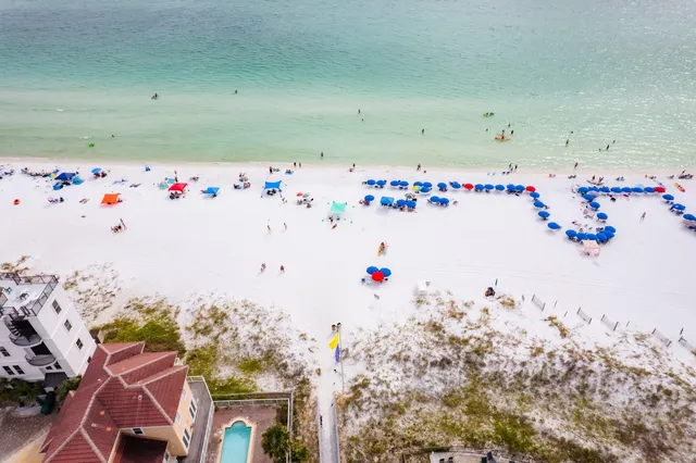 an aerial view of multiple houses with a yard