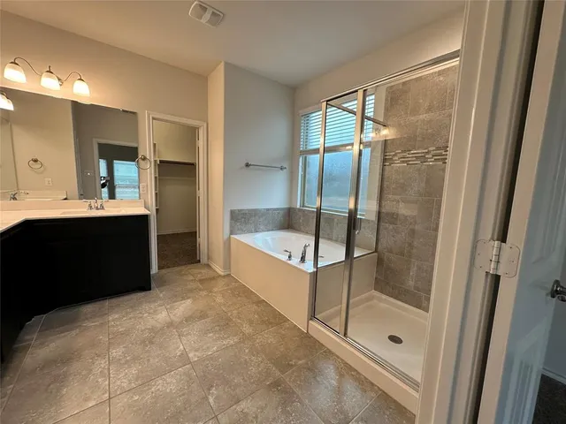 a bathroom with a glass door shower a sink and a mirror