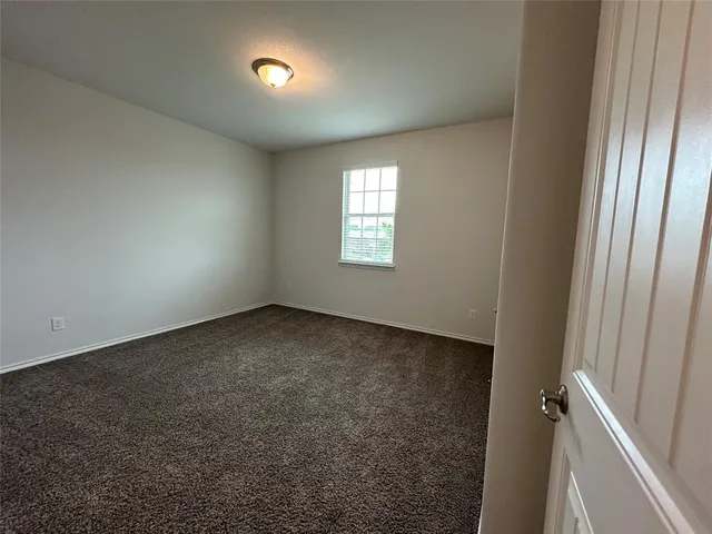 a view of an empty room and a window