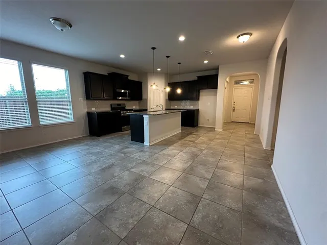 a large space with a large window and stainless steel appliances