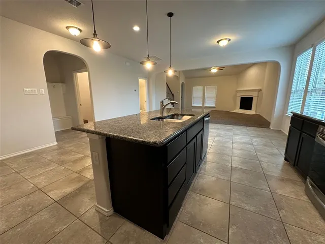 a kitchen with a sink a counter top space appliances and cabinets