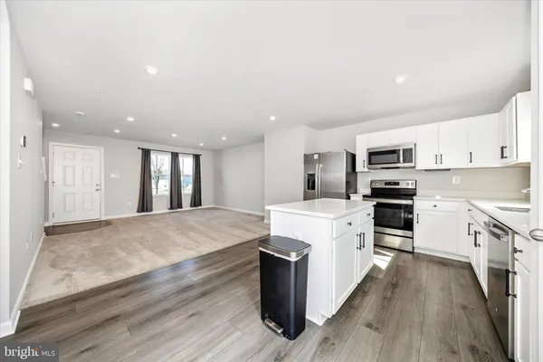a kitchen with a sink a stove a microwave and refrigerator