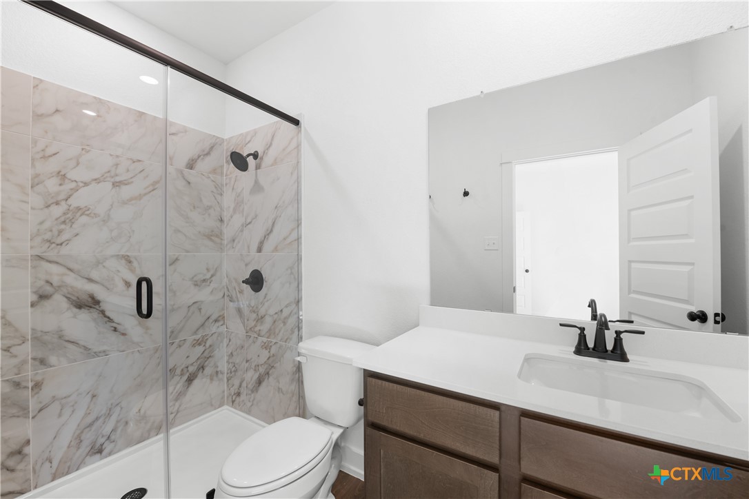 1727 Bear Grass Rdg Road Temple, TX 76501 - Photo 10 of 16 a bathroom with a sink toilet a mirror and shower