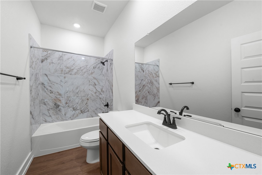 1727 Bear Grass Rdg Road Temple, TX 76501 - Photo 12 of 16 a bathroom with a sink toilet and shower