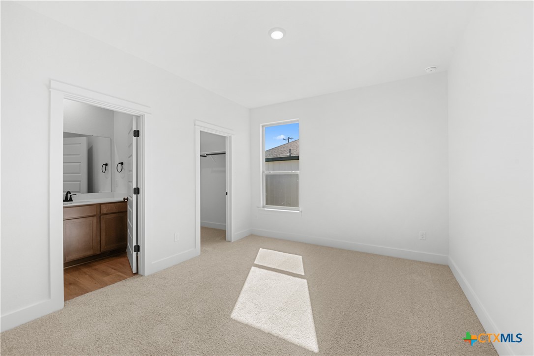 1727 Bear Grass Rdg Road Temple, TX 76501 - Photo 9 of 16 an empty room with windows and bathroom