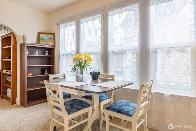 a view of a room with wooden floor and windows