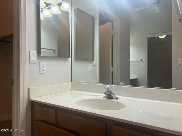 a white toilet sitting next to a white wall