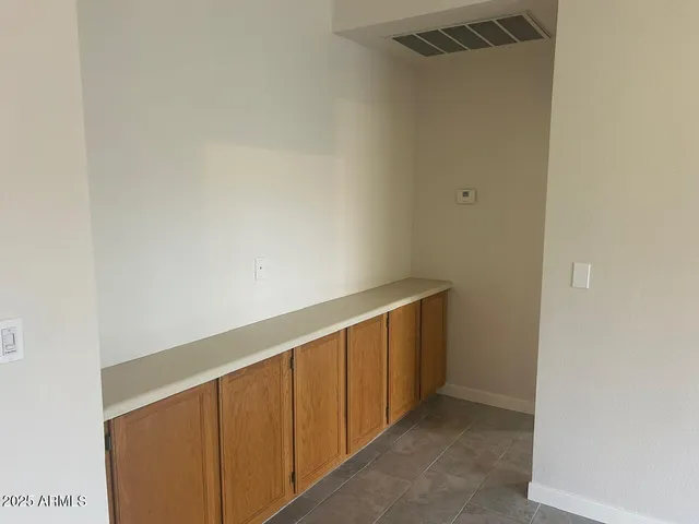 a view of porch with a table and chairs