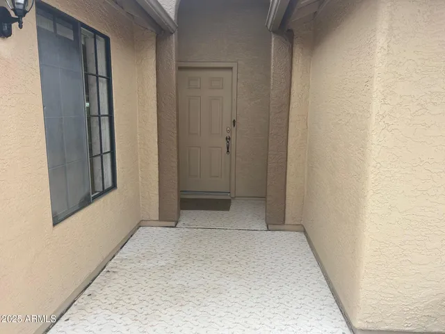 an empty room with fan and windows