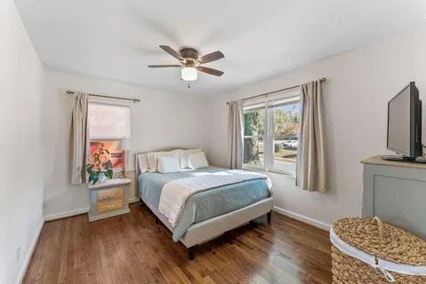 a bedroom with a bed and a television