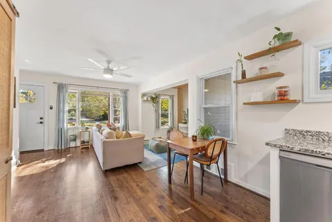 a living room with furniture and wooden floor