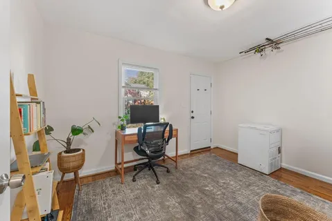 a workspace room with furniture and a window