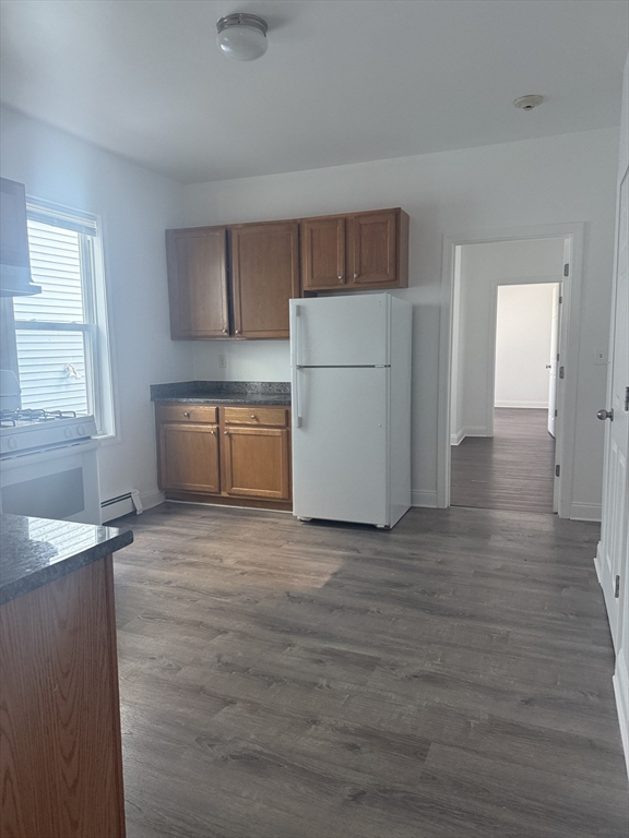 25 Highland Street, Unit 1L Revere, MA 02151 - Photo 2 of 11 a view of a kitchen with a sink dishwasher and wooden floor