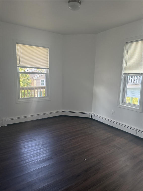 25 Highland Street, Unit 1L Revere, MA 02151 - Photo 3 of 11 a view of an empty room with wooden floor and a window