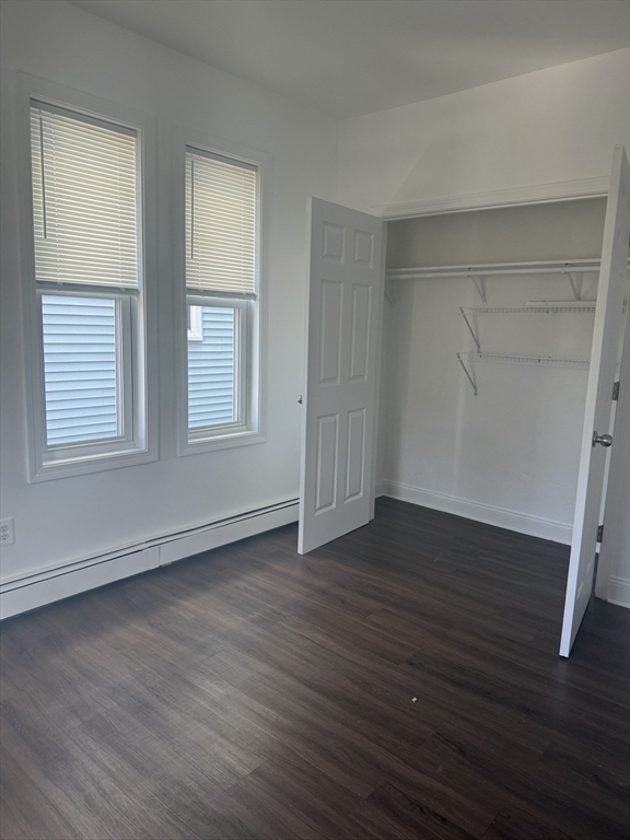 25 Highland Street, Unit 1L Revere, MA 02151 - Photo 4 of 11 an empty room with wooden floor and windows