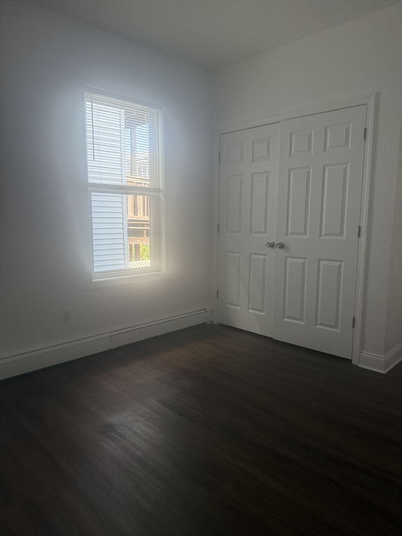 25 Highland Street, Unit 1L Revere, MA 02151 - Photo 6 of 11 a view of an empty room with wooden floor and a window