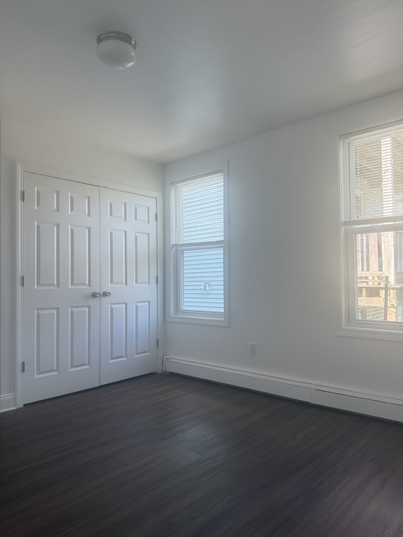 25 Highland Street, Unit 1L Revere, MA 02151 - Photo 8 of 11 an empty room with wooden floor and windows