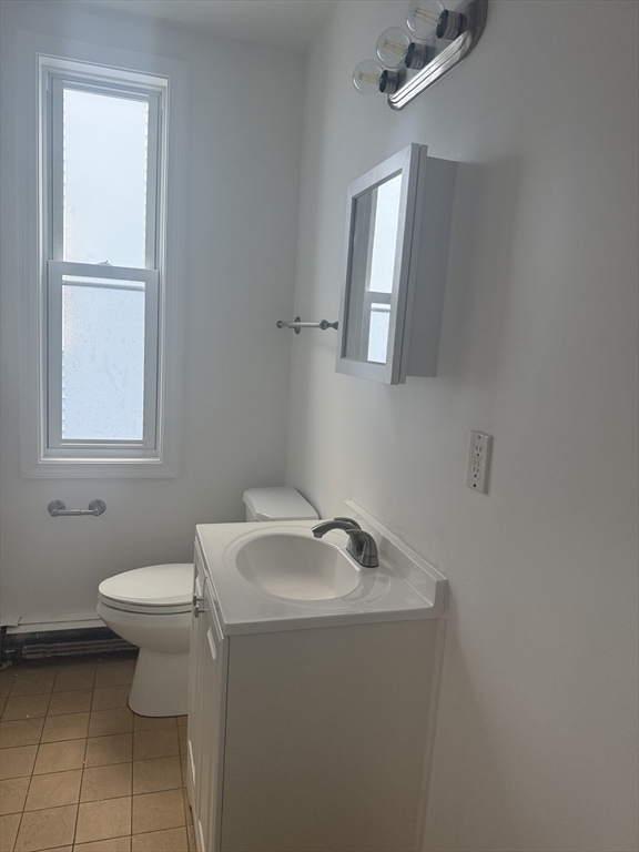 25 Highland Street, Unit 1L Revere, MA 02151 - Photo 10 of 11 a bathroom with a sink toilet and a mirror