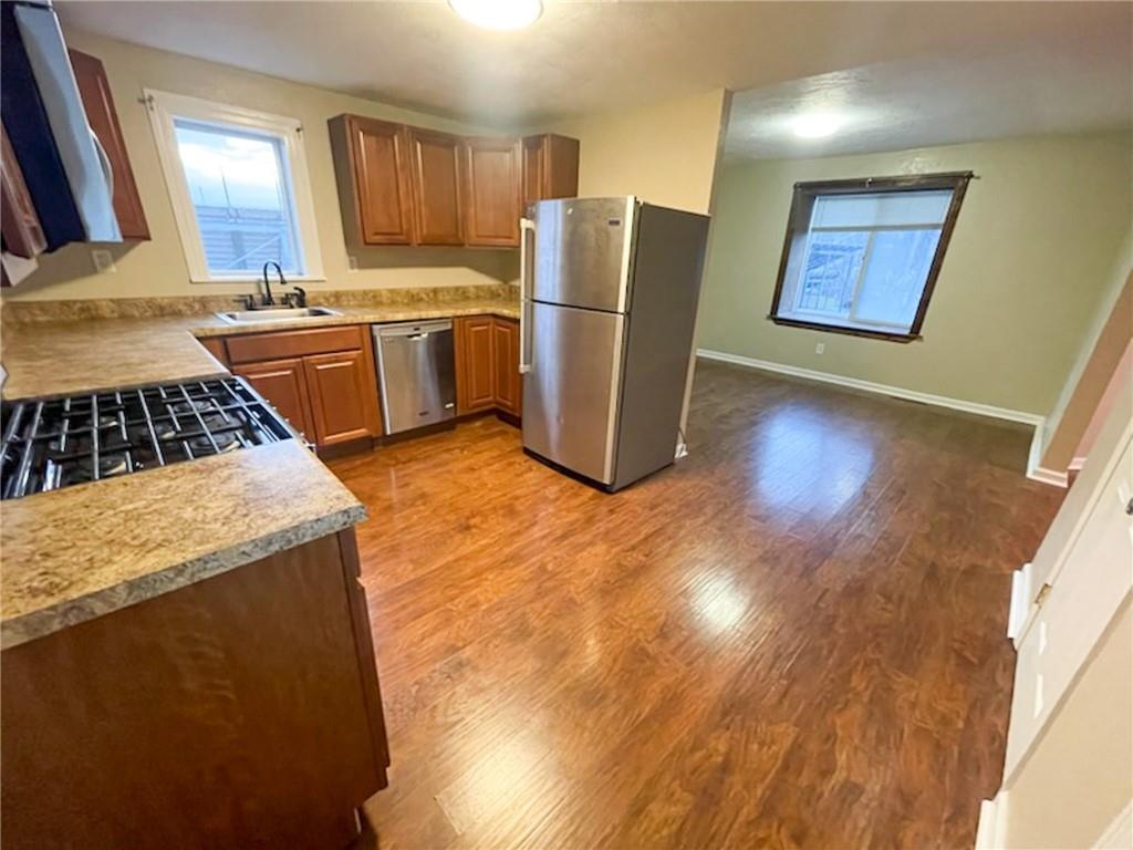 312 Jackson Avenue Vandergrift, PA 15690 - Photo 11 of 21 a kitchen with stainless steel appliances granite countertop a refrigerator a stove a sink and a microwave