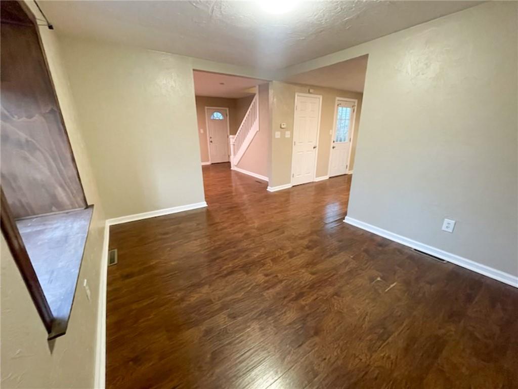 312 Jackson Avenue Vandergrift, PA 15690 - Photo 14 of 21 an empty room with wooden floor and entrance