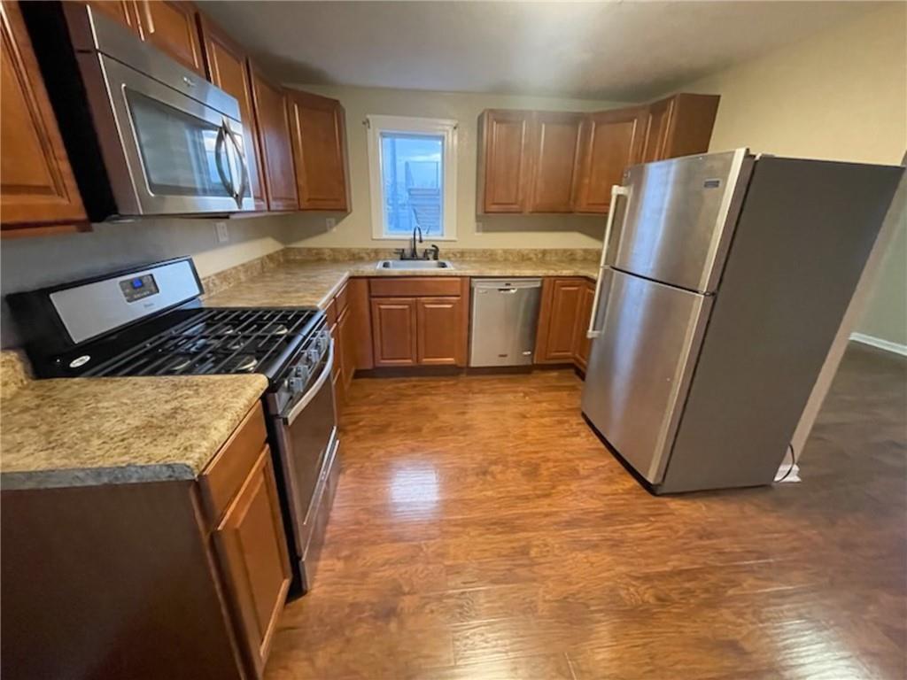 312 Jackson Avenue Vandergrift, PA 15690 - Photo 9 of 21 a kitchen with stainless steel appliances granite countertop a refrigerator a sink a stove a washer dryer and a refrigerator